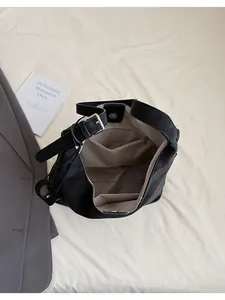 Top view of large capacity black tote bag showing beige lining and interior pockets