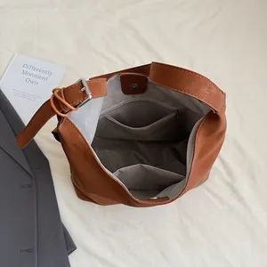 Brown large capacity tote bag showing gray herringbone lining and inner zipper pocket