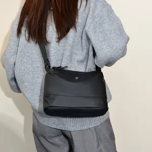 Minimalist black crossbody shoulder bag with adjustable strap for daily urban commute style