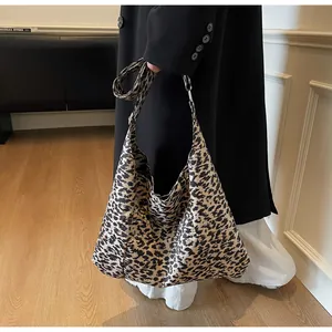 Détail du grand sac porté épaule en daim à motif léopard avec drapé souple et bandoulière