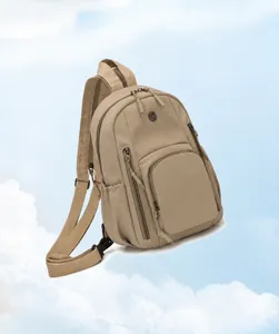 Detailed close-up of lightweight khaki backpack featuring front logo and zipper compartments