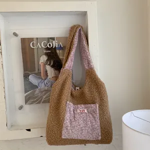 Brown fleece tote bag with pink leopard print pocket and cherry emblem in a cozy setting
