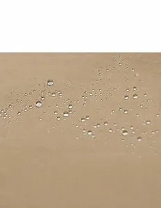 Macro detail of waterproof khaki nylon fabric with water droplets on the backpack