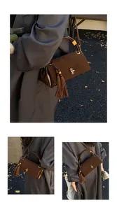 Close-up of retro dark brown suede shoulder bag with leather tassels and metal knob lock
