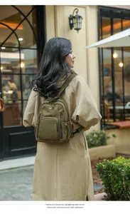 Outdoor shot of olive green nylon backpack featuring multiple functional zipper pockets