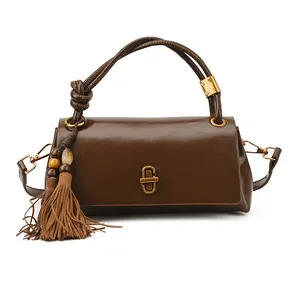 Brown rectangular shoulder bag with golden clasp and bohemian beaded tassel accessory