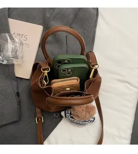 Top view of brown suede bucket bag interior showing spacious capacity for phone and wallet