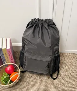 Detail of grey waterproof drawstring backpack with mesh side pockets and front zipper