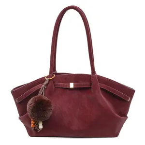 Retro burgundy faux suede tote bag with plush charm and metal buckle detail for women