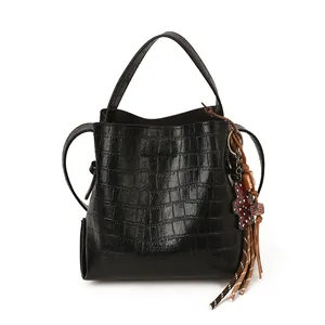 Chic black crocodile embossed bucket bag with a stylish tassel and heart charm pendant