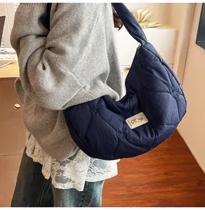 Detail of navy quilted cloud bag with heart patterns and soft feather down texture