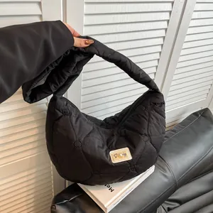 Fashionable black heart-quilted puffer tote bag with pearl detail and crescent shape