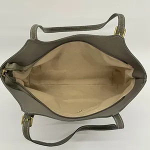 Large gray faux leather tote bag with white stitching and spacious beige interior