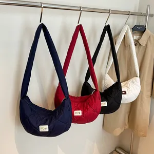 Quilted heart puff tote bags in navy, burgundy, black, and white colors on display