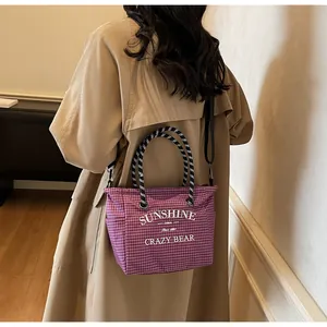 Detail of purple and white checkered canvas tote with rope handle and sunshine print