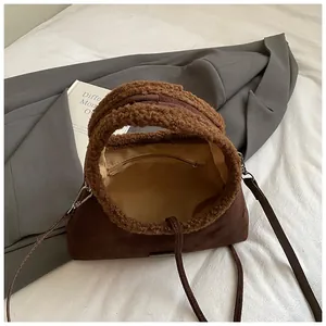Vintage dark brown suede handbag with fleece trim and detachable strap seen from top view