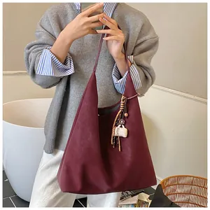 Deep burgundy suede tote bag featuring a creative coffee cup charm on the shoulder strap