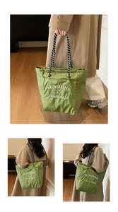 Detail of green checkered canvas tote with woven rope handles and sunshine lettering