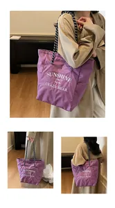 Detail of purple plaid tote bag with woven handles and Sunshine Crazy Bear print