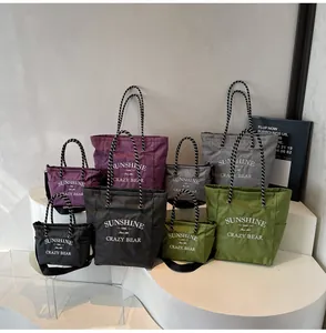 Detail of plaid tote bags in various sizes and colors on a white minimalist display