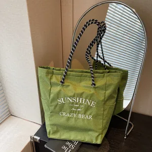 Green plaid canvas tote bag with sunshine embroidery and durable rope handles