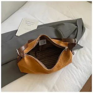 Brown textured leather shoulder bag with minimalist design and silver metal buckle