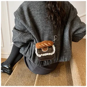 Close-up of a vintage brown bag with lace trim and plush bear baguette decoration