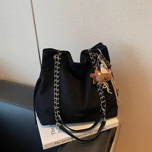 Minimalist black matte tote bag with dual chain straps and cute bear charm for daily use