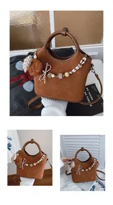 Detail der braunen Wildleder-Beuteltasche mit Prägung und süßem Plüschbär-Anhänger