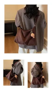 Close-up of brown oversized tote bag with a cute crochet ice cream charm pendant