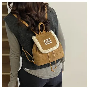 Brown faux suede backpack featuring white faux shearling trim and drawstring flap closure
