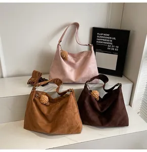 Detailed macro view showing suede texture and various colors of large hobo tote bags