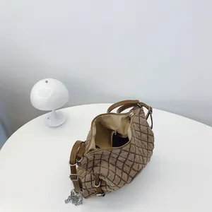 Brown quilted tote bag with chain strap and adjustable shoulder strap for women