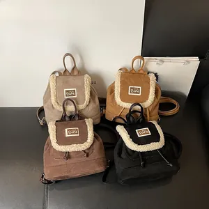Collection of four vintage drawstring backpacks with fleece trim and bear logos in various colors
