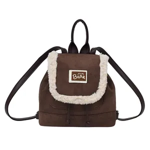 Vintage brown suede drawstring backpack with white faux fur trim and bear patch