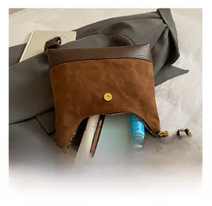 Detail showing the internal storage capacity of the brown suede quilted crossbody bag