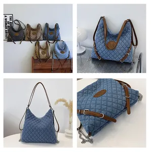 Close-up of quilted denim tote bags in multiple colors with leather handles and M logo