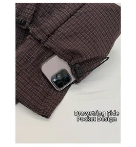 Detailed view of brown checkered tote with a functional drawstring side pocket for phone