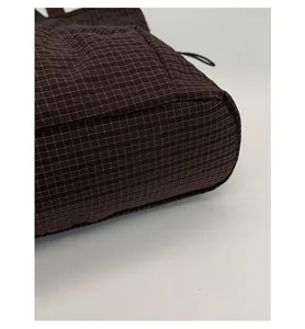 Close-up of the reinforced bag bottom showing durable grid texture and sturdy shape