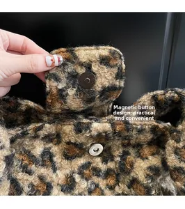 Close-up of the secure magnetic closure on a leopard print plush faux fur handbag