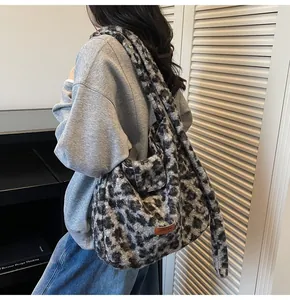 Detail of plush leopard print shoulder bag with soft faux fur texture and leather patch