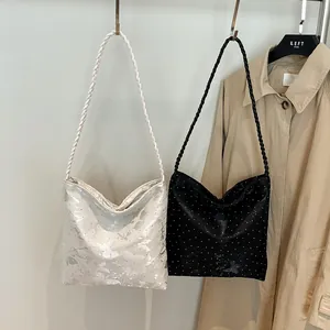 Minimalist Hobo bucket bags with woven straps in silver floral and black polka dot prints