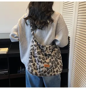 Detail of plush leopard print shoulder bag featuring a brown leather brand tag