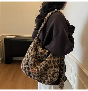 Close-up of leopard print faux fur shoulder bag with brand logo and plush texture