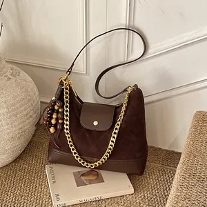 Vintage brown suede chain shoulder bag with quilted leather detail and tassel