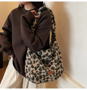 Detail shot of fluffy leopard print plush shoulder bag with leather logo patch texture