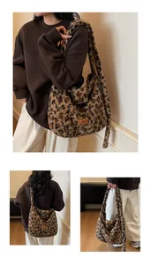 Detail of plush leopard print tote bag featuring a leather logo tag and fuzzy texture