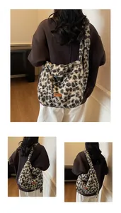 Close-up of leopard print plush shoulder bag with high-texture faux fur and orange tag