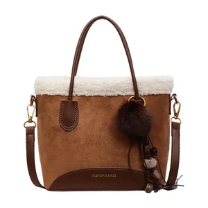 Brown suede shoulder bucket bag with white faux fur trim and fashion pompom charm