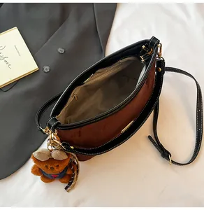 Internal view of leopard print bag with grey lining, zipper pocket and cute bear charm